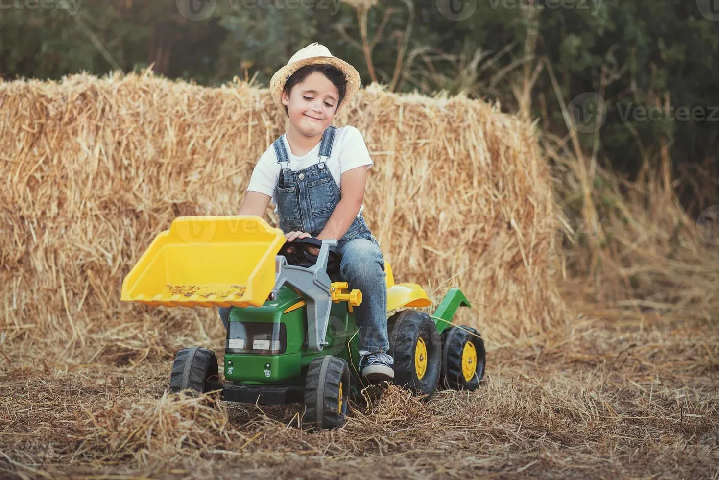 child playing with diecast tractor pulling toys