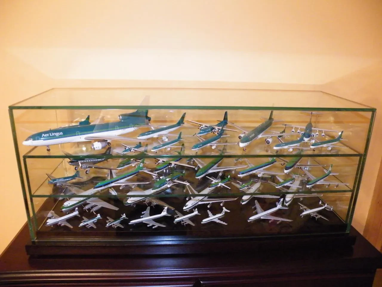 A shelf displaying a collection of diecast airplanes