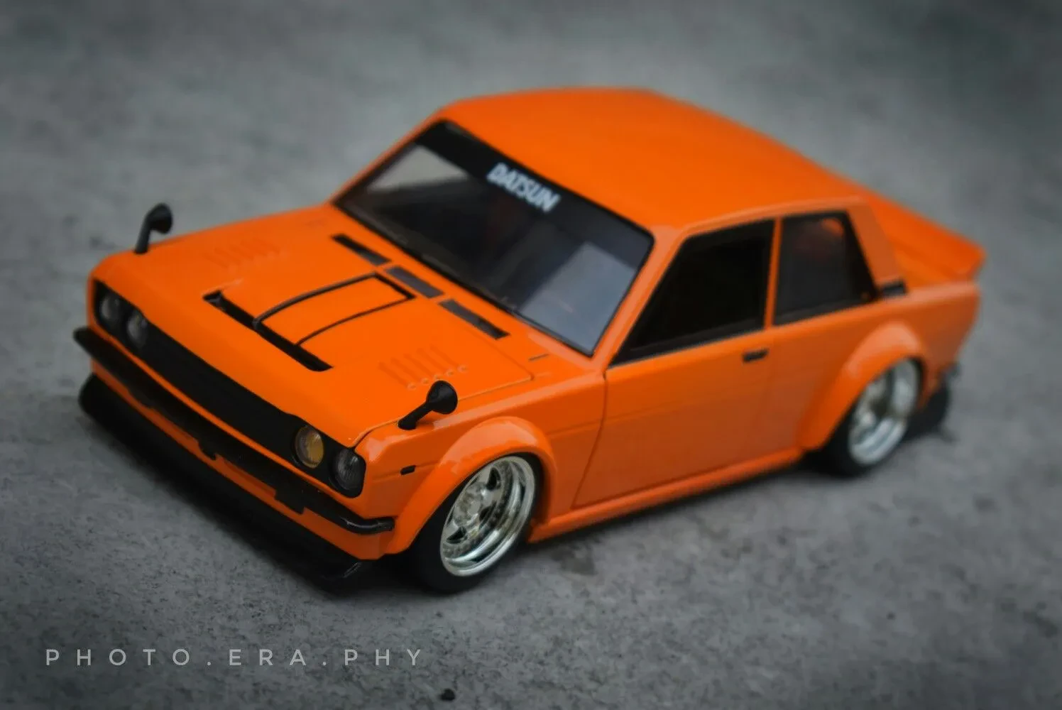 Datsun 510 diecast model with custom wheels and stance